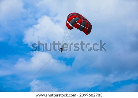 Parasailing activity on beach at sunny afternoon