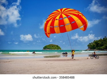 Parasailing extreme sports on beach in blue sky background 