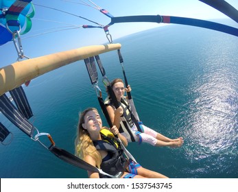 Parasailing flying above the Black sea. Happy mother and daughter on holidays.
