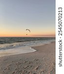 Parasailing into the December sunset while the waves crash