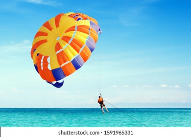 Parasailing on Tropical Beach. Freedom in fly on parachute.