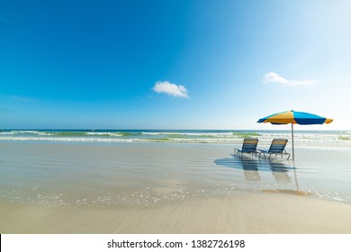 Parasol And Beach Chairs On The Foreshore In Daytona Beach. Florida, USA