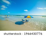Parasols and beach chairs in Daytona Beach foreshore. Florida, USA