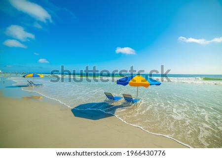 Parasols and beach chairs in Daytona Beach foreshore. Florida, USA