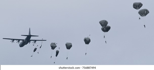 Paratroopers Jump From C-130 Hercules Military Plane On Evening