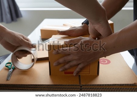 parcel boxes being packaged and ready to be sent to customers who have placed online orders within the online store's system. A small SME businessman has prepared the parcels and is ready for delivery