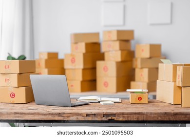 Parcel boxes on shelf and color shopping bags placing near laptop on table. SME business on shopping online at home office packaging on background is popular business.
 - Powered by Shutterstock