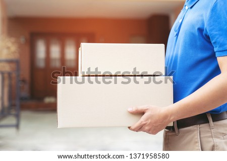 parcel delivery man of a package through a service send to home. consign hand Submission customer accepting a delivery of boxes from delivery man. 