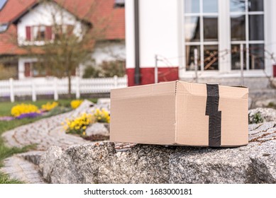 Parcel From Postal Delivery Is Left In The Garden Because The Recipient Is Not At Home.