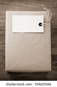 parcel wrapped packaged box on wooden background
