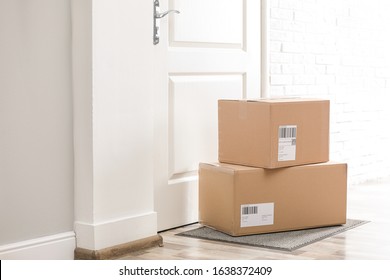 Parcels on rug near door. Delivery service