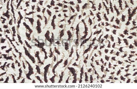 pard print on mass produced fabric. Abstract animal skin pattern, background. A fabric sample from a shop window.
A piece of fabric from a shop window.Dyeing fabric under the skin of a leopard, 