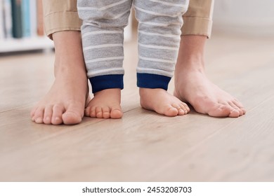 Parent and baby feet, learning for growth, support and first steps to healthy development in closeup. Person, teaching and child to walk, balance and fine motor skills at home with love and hope - Powered by Shutterstock - Get 15% off with code: PIKWIZARD15