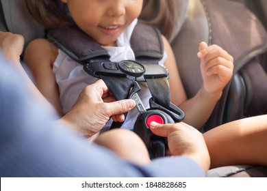 Parent Buckling Her Child's Seat Belt In The Car. Transportation Safety.