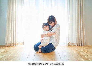 Parent and child hugging in the room