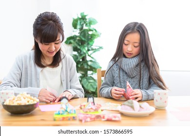 Parent And Child Making Origami