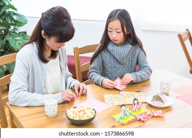 Parent And Child Making Origami