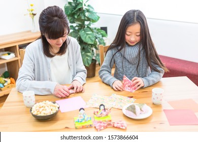 Parent And Child Making Origami