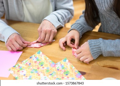 Parent And Child Making Origami