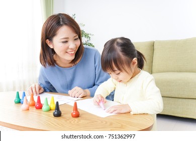 A Parent And Child Painting A Picture