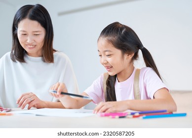 Parent and child playing and drawing in the room - Powered by Shutterstock