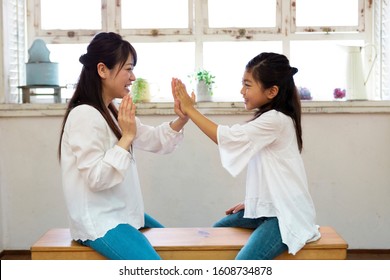 Parent And Child Playing On The Bench