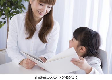 Parent And Child Reading A Book