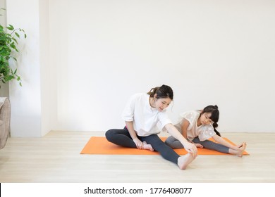 Parent And Child Stretching At Home