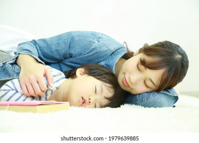 Parent And Child Taking A Nap 
