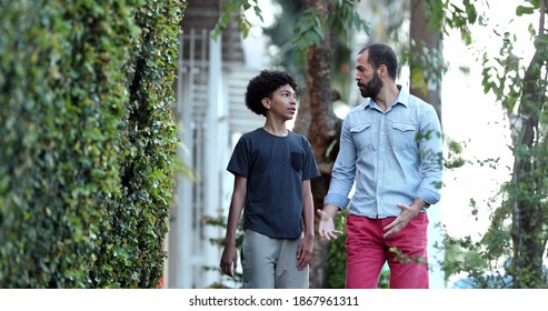 Parent And Child Walking Together. Father Giving Advice To Son, Dad And Kid Bonding