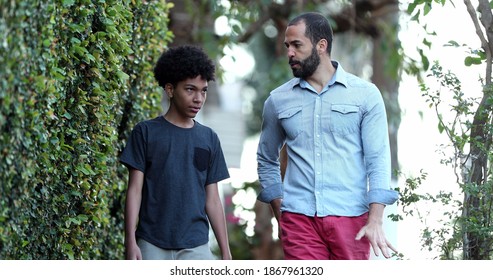 Parent And Child Walking Together. Father Giving Advice To Son, Dad And Kid Bonding