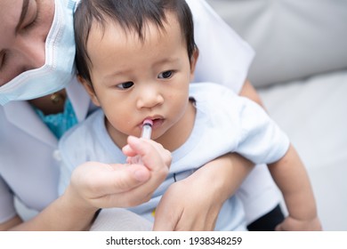 
Parent feed the medicine Asian baby boy.Boy catch an infection and take medicine by syringe, oral syringe.Selective focus.