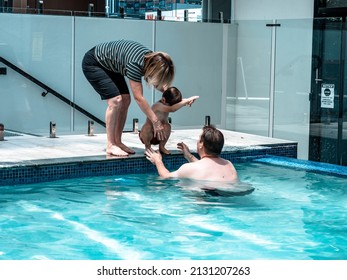 Parent And Grandma Teaching Child To Swim