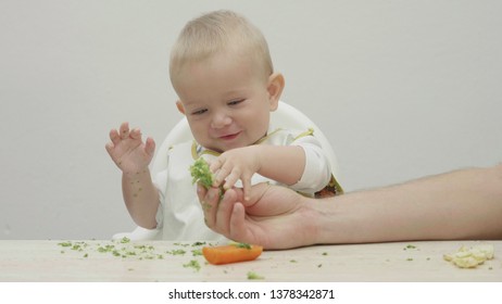 Parent Hand Offer Food To Baby, Smiling Child Playing With Food