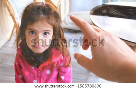 parent hand yelling blaming and scolding child reproaching baby girl daughter . Stock photo © 