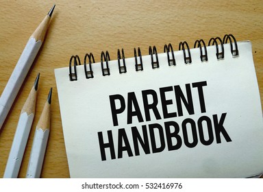 Parent Handbook Text Written On A Notebook With Pencils