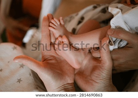 Parent hands gently cradling tiny baby feet, capturing the delicate beauty of a newborn, representing the profound connection and loving care within a family