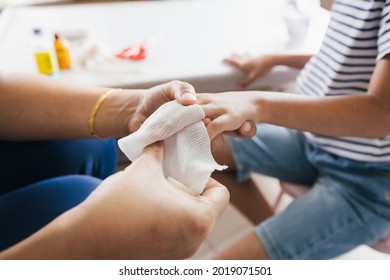 Parent Helping Her Child Perform First Aid Finger Injury After She Has Been An Accident.