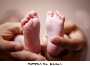 parent holding newborn baby feet. family concept - Powered by Shutterstock