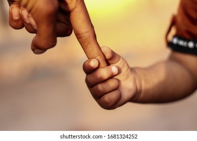 a parent holds the hand of a small child,hands of parent and child in nature,trustable hand - Shutterstock ID 1681324252