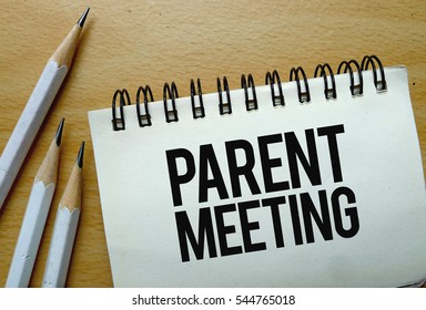 Parent Meeting text written on a notebook with pencils