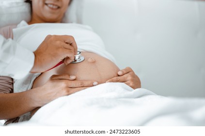 parent, prenatal, pregnancy, motherhood, pregnant, childbirth, stethoscope, patient, healthcare, heartbeat. A doctor is examining a pregnant woman and using a stethoscope to listen baby's heartbeat. - Powered by Shutterstock