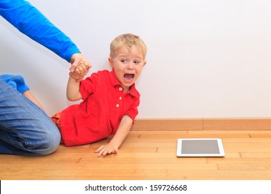 Parent Pulling Child From Touch Pad. Computer Addiction