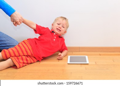 Parent Pulling Child From Touch Pad. Computer Addiction