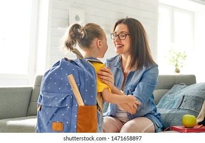 Parent and pupil of preschool. Woman and girl with backpack behind back. Beginning of lessons. First day of fall. - Shutterstock ID 1471658897