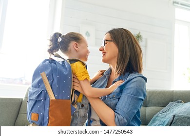 Parent and pupil of preschool. Woman and girl with backpack behind back. Beginning of lessons. First day of fall. - Shutterstock ID 1477250543