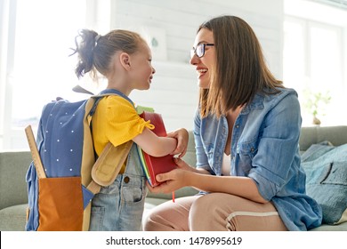 Parent and pupil of preschool. Woman and girl with backpack behind back. Beginning of lessons. First day of fall. - Shutterstock ID 1478995619