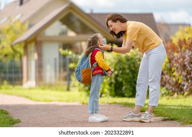 Parent And Pupil Of Secondary School Going Hand In Hand. Woman And Girl With Backpack Behind The Back. Beginning Of Lessons. 