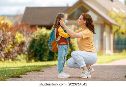 Parent And Pupil Of Secondary School Going Hand In Hand. Woman And Girl With Backpack Behind The Back. Beginning Of Lessons. 