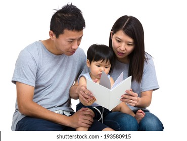 Parent Reading Book With Baby Son